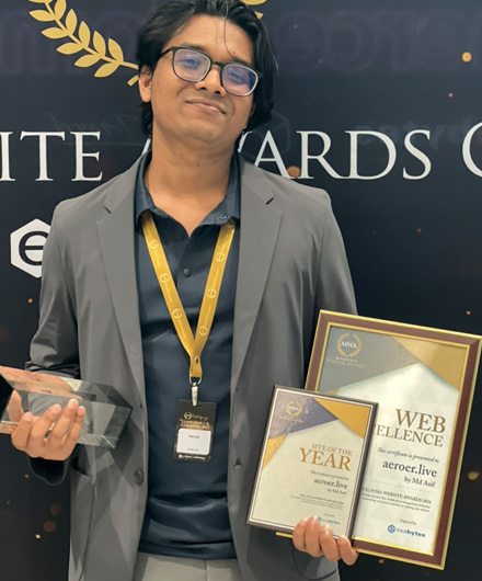Mohammed Asif holding awards at the Malaysia Website Awards